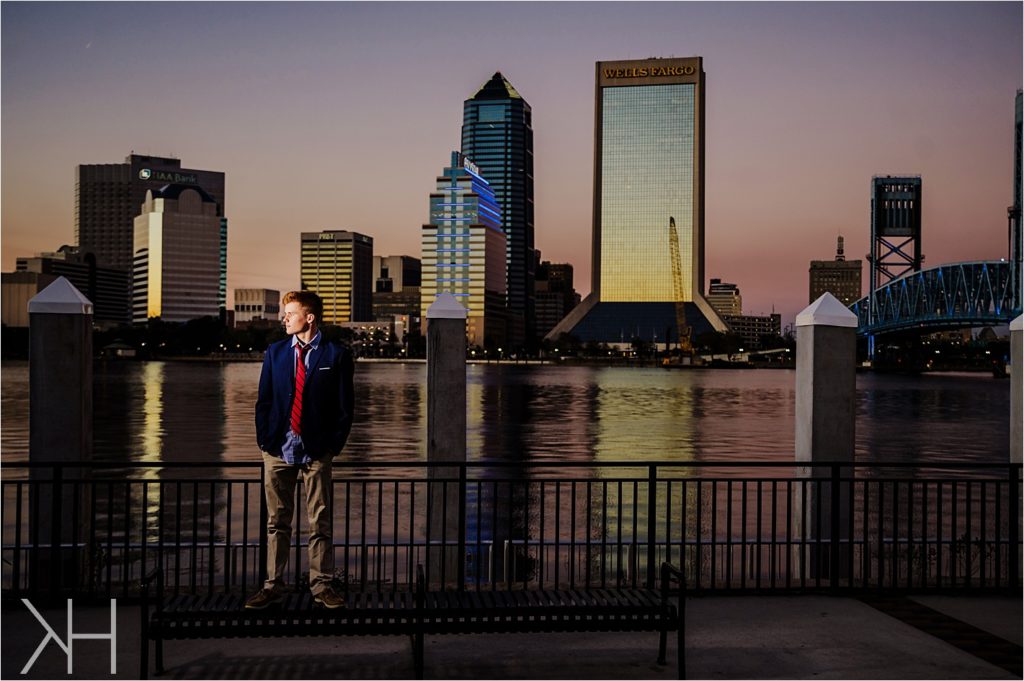 Downtown Jacksonville Guys senior with photos at sunset in a suit. 