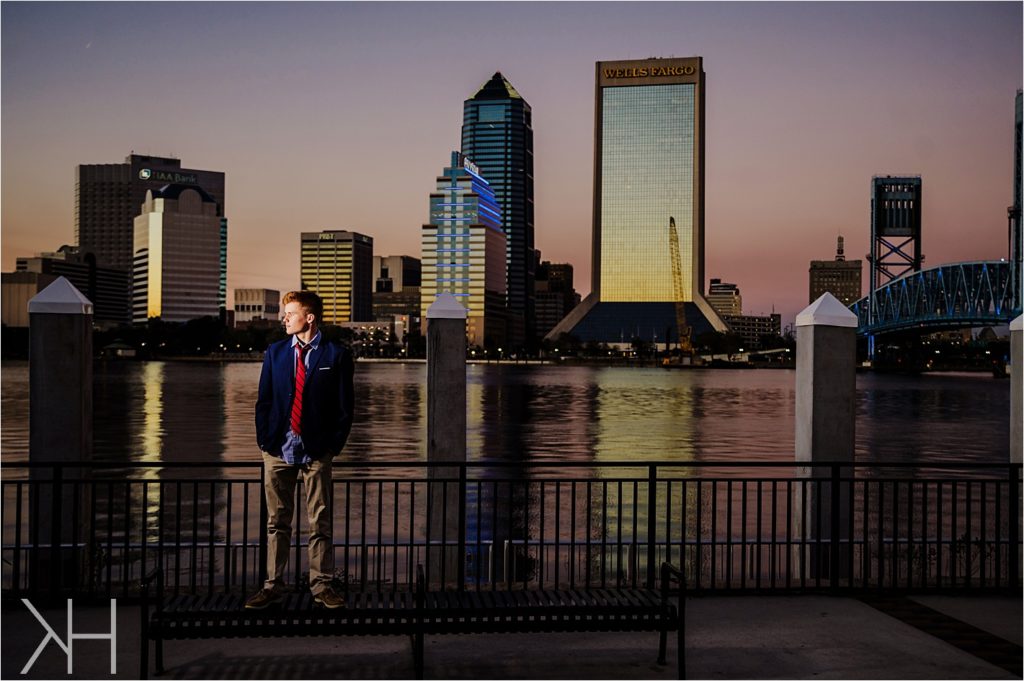 Downtown Jacksonville Guys senior with photos at sunset in a suit.